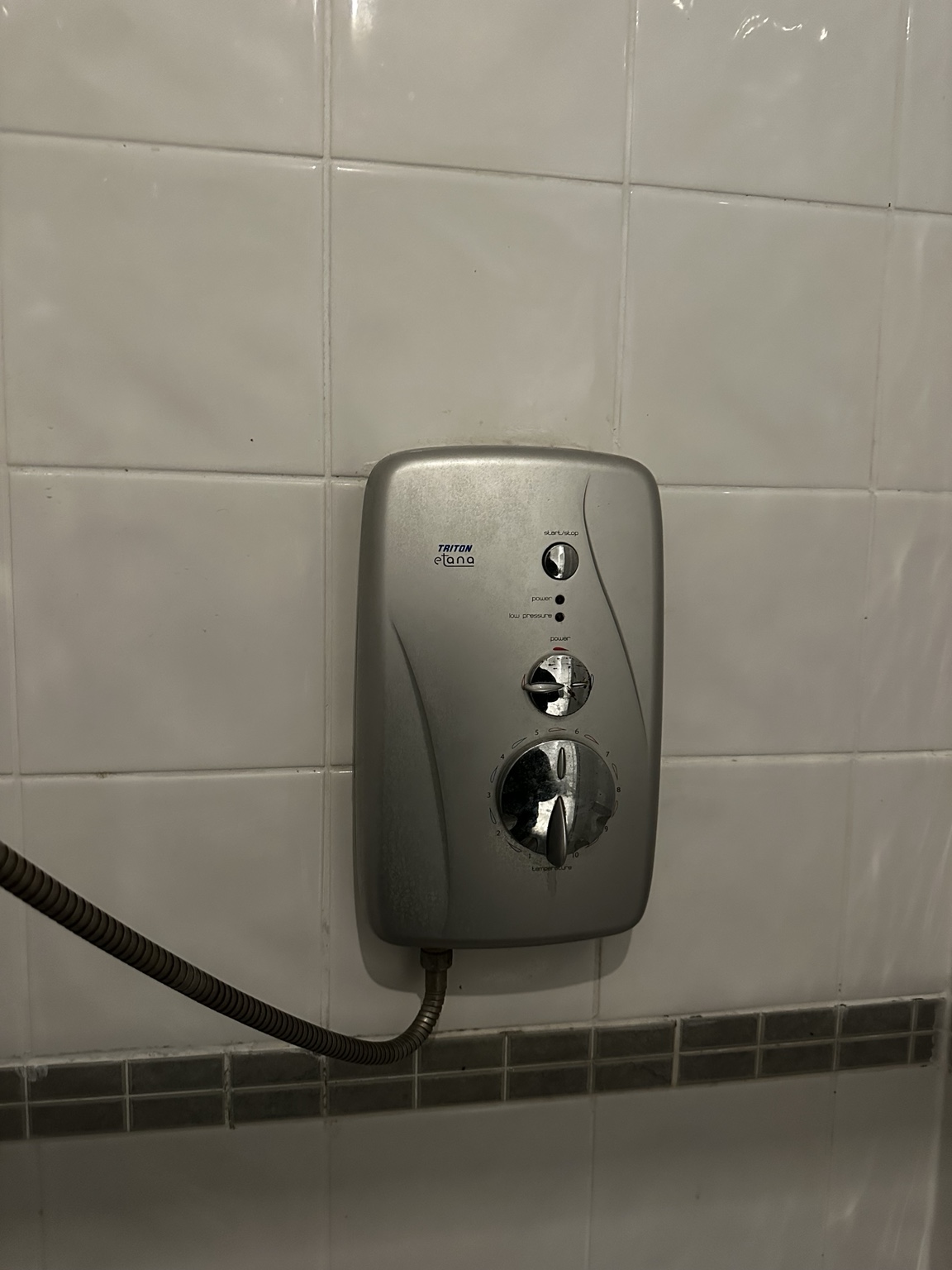 Original silver Triton electric shower before replacement