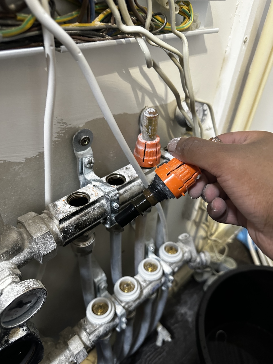 Flow meter removed from the underfloor-heating manifold during repair