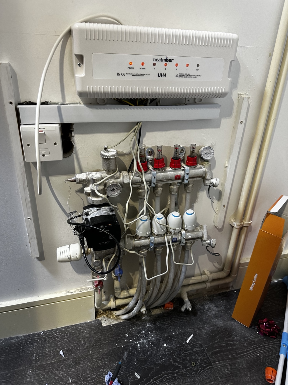 Underfloor-heating manifold with pump, four actuators and Heatmiser wiring centre fitted