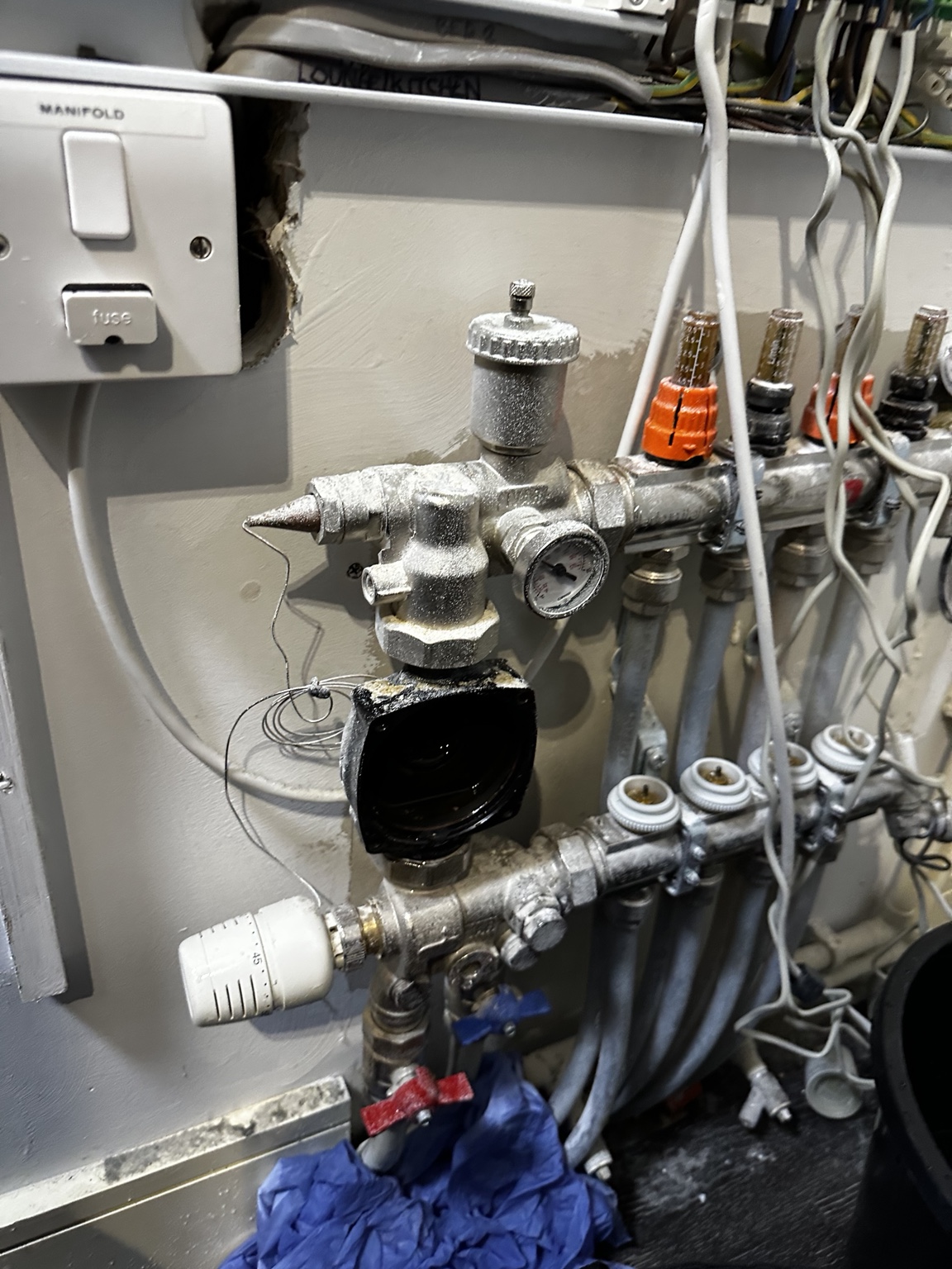 Underfloor-heating pump housing with motor head removed during repair